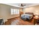 Bedroom boasts wood floors, lots of natural light, and a padded headboard at 5615 Criollo Dr, Las Vegas, NV 89122