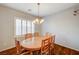 Bright dining room featuring hardwood floors, a chandelier, and a large window at 5615 Criollo Dr, Las Vegas, NV 89122