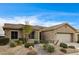 Single-story home with well-maintained desert landscaping and neutral tones at 5615 Criollo Dr, Las Vegas, NV 89122