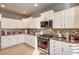 Modern kitchen with white cabinetry, stainless steel appliances, and granite countertops at 5615 Criollo Dr, Las Vegas, NV 89122