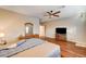 Spacious bedroom with wood floors, ceiling fan, and dresser with decorative mirror at 5615 Criollo Dr, Las Vegas, NV 89122