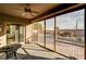 Enclosed patio featuring a ceiling fan and sliding glass doors to the landscaped backyard at 5615 Criollo Dr, Las Vegas, NV 89122