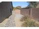 Low maintenance side yard with rock landscaping, a small gate and privacy wall at 5615 Criollo Dr, Las Vegas, NV 89122