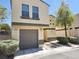Tan two-story house with a brown garage door at 6104 Daisy Lee Ave, Las Vegas, NV 89108