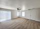 Spacious living room with neutral carpeting and sliding glass door at 6104 Daisy Lee Ave, Las Vegas, NV 89108