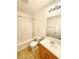 Clean bathroom with tub, toilet and wood vanity at 6149 Ethel May Ave, Las Vegas, NV 89108