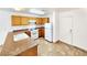 Kitchen with wood cabinets, tile floors, and white appliances at 6149 Ethel May Ave, Las Vegas, NV 89108