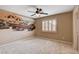 Bedroom with ceiling fan, mural, and neutral carpet at 6203 Sun Seed Ct, North Las Vegas, NV 89081