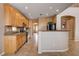 Spacious kitchen with light wood cabinets, granite countertops, and tile flooring at 6203 Sun Seed Ct, North Las Vegas, NV 89081