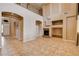 Two story living room with fireplace and built-in shelving at 6203 Sun Seed Ct, North Las Vegas, NV 89081