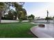 Landscaped backyard with a fire pit and pool at 7045 Edna Ave, Las Vegas, NV 89117