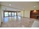 Open concept basement with sliding doors to patio and wet bar at 7045 Edna Ave, Las Vegas, NV 89117