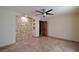 Bright bedroom with tile floors, ceiling fan, and built-in shelving at 7045 Edna Ave, Las Vegas, NV 89117