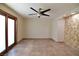 Spacious bedroom with tile floors, sliding doors, and ceiling fan at 7045 Edna Ave, Las Vegas, NV 89117