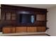Built-in entertainment center with shelving and cabinets at 7045 Edna Ave, Las Vegas, NV 89117