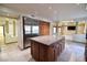 Gourmet kitchen with large island, stainless steel appliances, and wood cabinets at 7045 Edna Ave, Las Vegas, NV 89117