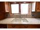 Kitchen sink with granite countertop and double window at 7045 Edna Ave, Las Vegas, NV 89117