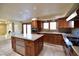 Gourmet kitchen with island, stainless steel appliances, and wood cabinetry at 7045 Edna Ave, Las Vegas, NV 89117