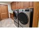 Bright laundry room with wood cabinets and modern LG appliances at 7045 Edna Ave, Las Vegas, NV 89117