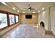 Spacious living room featuring a fireplace and a large TV at 7045 Edna Ave, Las Vegas, NV 89117