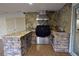 Outdoor kitchen with granite countertops, Wolf grill, and stone facade at 7045 Edna Ave, Las Vegas, NV 89117
