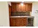 Basement wet bar with wood cabinets and granite countertop at 7045 Edna Ave, Las Vegas, NV 89117