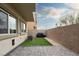 Small backyard with artificial turf, grill, and patio at 7455 Snowy Owl St # 102, North Las Vegas, NV 89084