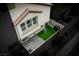 Private backyard with artificial turf, patio, and water feature at 7455 Snowy Owl St # 102, North Las Vegas, NV 89084