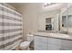 Bathroom with toilet, shower, and granite countertop at 7455 Snowy Owl St # 102, North Las Vegas, NV 89084
