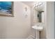 Clean and well-lit half bathroom with pedestal sink at 7455 Snowy Owl St # 102, North Las Vegas, NV 89084
