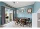 Bright dining area with a wooden table and access to the backyard at 7455 Snowy Owl St # 102, North Las Vegas, NV 89084