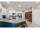 Island kitchen with granite countertops and teal cabinets at 7455 Snowy Owl St # 102, North Las Vegas, NV 89084
