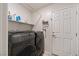 Convenient laundry room with washer, dryer, and storage shelves at 7455 Snowy Owl St # 102, North Las Vegas, NV 89084