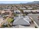 Wide aerial view of a home with solar panels nestled in a suburban community with mountain views at 7520 Darian Jane St, Las Vegas, NV 89149
