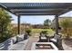 Inviting covered patio featuring a fire pit and comfortable seating area, perfect for outdoor relaxation at 7520 Darian Jane St, Las Vegas, NV 89149