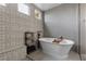 Bathroom featuring a freestanding tub, decorative tilework, and modern fixtures, creating a spa-like atmosphere at 7520 Darian Jane St, Las Vegas, NV 89149