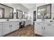 Luxurious bathroom featuring dual vanities, a makeup area, sleek mirrors, and modern fixtures at 7520 Darian Jane St, Las Vegas, NV 89149