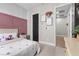 Charming bedroom featuring a pink accent wall, plush decor, and soft lighting for a cozy and inviting atmosphere at 7520 Darian Jane St, Las Vegas, NV 89149