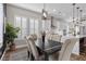 Inviting dining area with modern lighting, plantation shutters, and a view into the open kitchen at 7520 Darian Jane St, Las Vegas, NV 89149