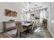 Elegant dining room with a large table, modern lighting, and neutral colors at 7520 Darian Jane St, Las Vegas, NV 89149