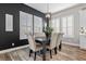 Stylish dining area with plantation shutters, modern lighting, wainscoting, and adjacent to the kitchen at 7520 Darian Jane St, Las Vegas, NV 89149