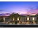 Charming single-story home boasts manicured landscaping, warm lighting, and a welcoming entrance at 7520 Darian Jane St, Las Vegas, NV 89149