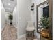 Hallway featuring wood-look floors, modern lighting, accent furniture, and a view to another room at 7520 Darian Jane St, Las Vegas, NV 89149