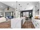 Open-concept kitchen with a large island, white cabinets, stainless steel appliances, and seamless flow to the living area at 7520 Darian Jane St, Las Vegas, NV 89149