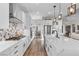 Modern kitchen featuring white cabinets, stainless steel appliances, a large island, and designer backsplash at 7520 Darian Jane St, Las Vegas, NV 89149