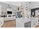 Open-concept kitchen with a large island, marble counters, and modern finishes at 7520 Darian Jane St, Las Vegas, NV 89149