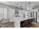 Beautiful kitchen featuring white cabinetry, stainless steel appliances, and stylish pendant lights at 7520 Darian Jane St, Las Vegas, NV 89149