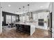 Modern kitchen featuring white cabinetry, stainless steel appliances, and a large center island at 7520 Darian Jane St, Las Vegas, NV 89149