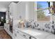 Well-lit kitchen showcasing white cabinetry, light countertops, modern appliances, and a stylish backsplash at 7520 Darian Jane St, Las Vegas, NV 89149