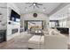 Cozy living room showcasing a fireplace, large TV, hardwood floors, and seamless flow to the kitchen at 7520 Darian Jane St, Las Vegas, NV 89149